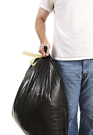 man holding a trash bag